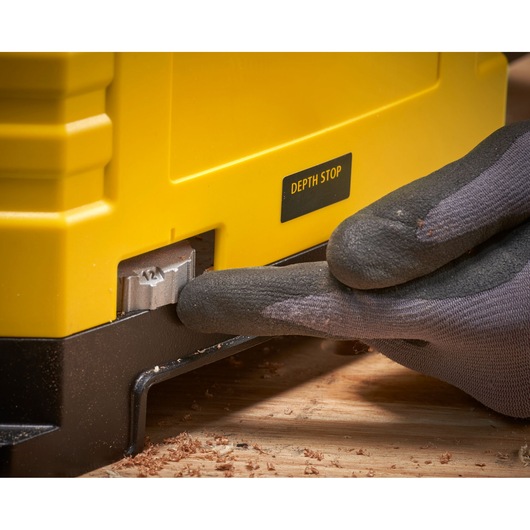 STANLEY STP18-B2 photography of depth stop adjustment on yellow woodworking tool, close-up angle.