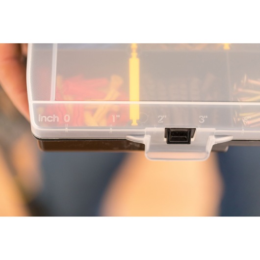 STANLEY STST81681-1 photography of plastic organizer lid with inch scale and latch, close-up view.