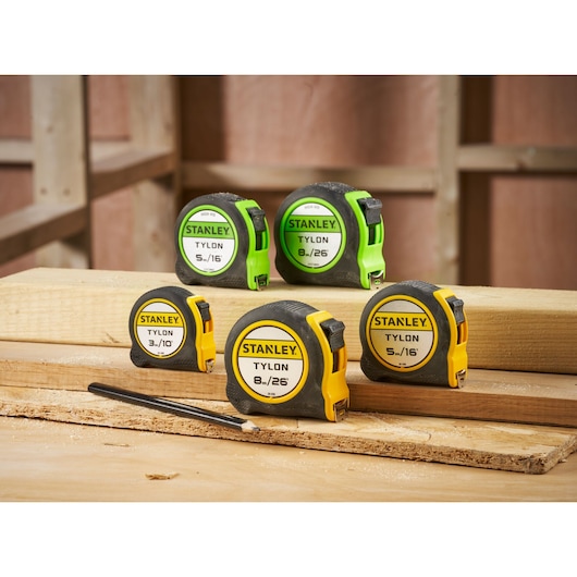 STANLEY STHT30604-1 tape measures assorted sizes on wood surface, construction photography.